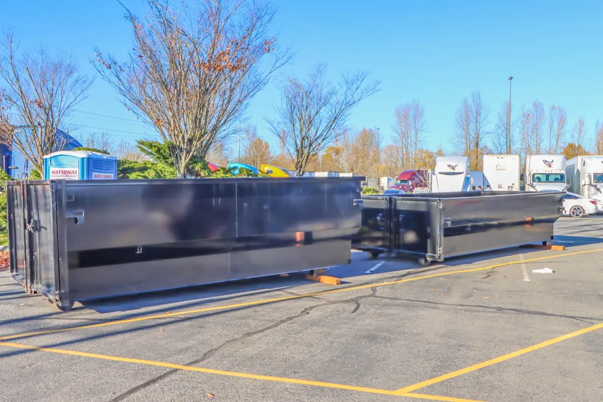 Professional dumpster rental service with roll-off container on residential driveway in Prescott Valley